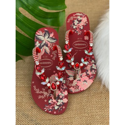 Red women slippers decorated with flowers and stones Red women slippers decorated with flowers and stones